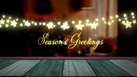 Animation-of-fairy-lights-and-seasons-greetings-text-over-wooden-boards