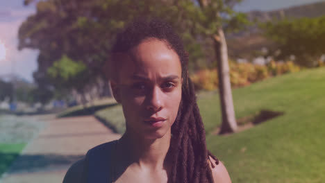 Spots-of-light-against-close-up-of-african-american-woman-in-the-park