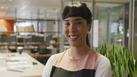 Portrait-of-happy-caucasian-businesswoman-in-empty-office