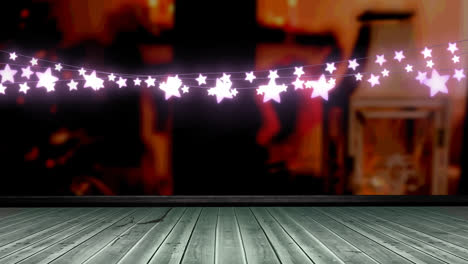 Glowing-pink-star-shaped-fairy-light-decoration-hanging-over-wooden-plank