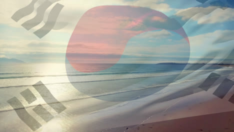 Digital-composition-of-waving-south-korea-flag-against-aerial-view-of-beach-and-sea-waves