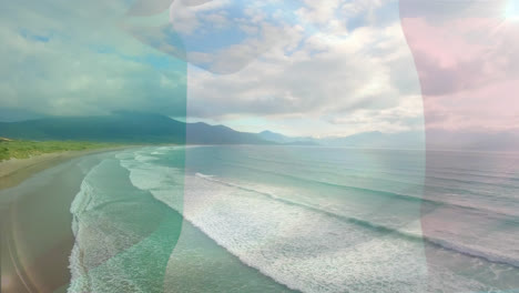 Animation-of-flag-of-italy-blowing-over-beach-landscape