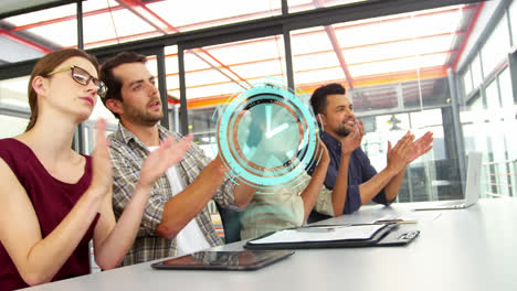 Animation-of-clock-over-happy-diverse-male-and-female-business-colleagues-clapping-hands-in-office