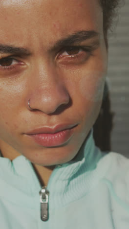 Light-spot-against-close-up-of-portrait-of-african-american-fit-woman