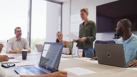 Diverse-male-and-female-business-colleagues-discussing-at-meeting