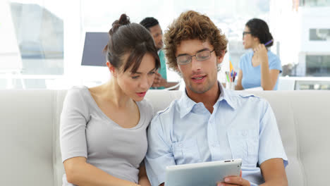 Colleagues-chatting-on-the-couch-with-tablet-