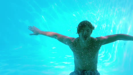 Hombre-Feliz-Posando-Bajo-El-Agua-En-La-Piscina