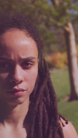 Spots-of-light-against-close-up-of-african-american-woman-in-the-park