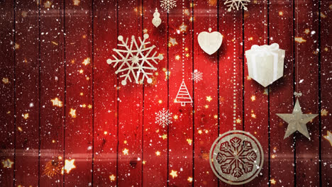 Animation-of-snow-falling-over-christmas-decorations-on-red-background