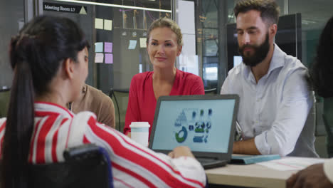 Happy-diverse-male-and-female-business-colleagues-and-disabled-businesswoman-talking-in-office