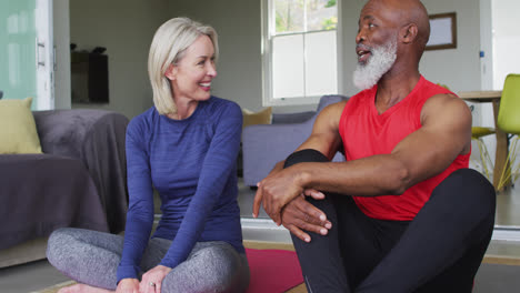 Mixed-race-senior-couple-talking-to-each-other-at-home