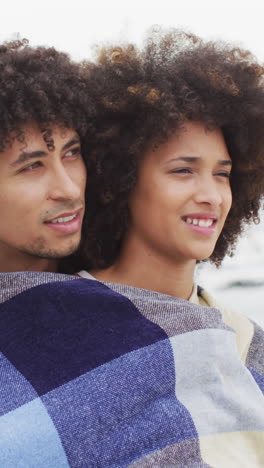 Biracial-couple-enjoys-a-moment-outdoors,-with-copy-space