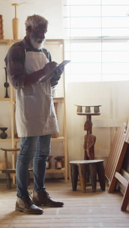 African-American-artist-reviews-his-work-in-a-sunlit-studio