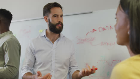 Diverse-male-and-female-business-colleagues-brainstorming-at-meeting-in-office