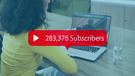 Animation-of-numbers-and-subscribers-text-over-biracial-businesswoman-on-laptop-video-call