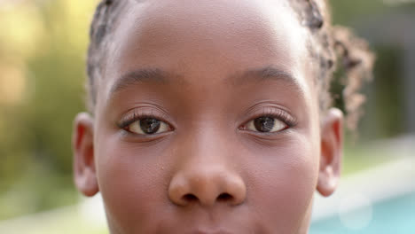 Portrait-close-up-happy-african-american-girl-smilling-in-garden,-in-slow-montion