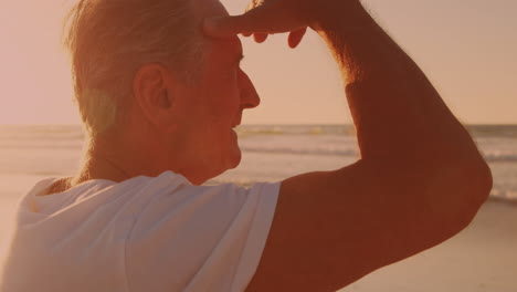 Rear-view-of-caucasian-senior-man-enjoying-the-view-at-the-beach