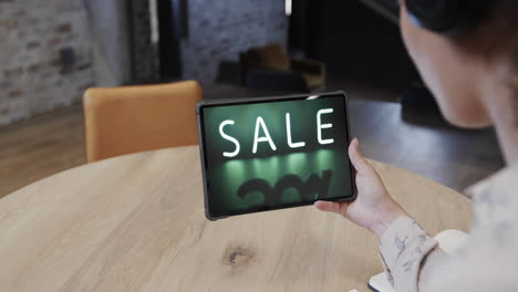 Biracial-woman-using-tablet-at-cafe-for-online-shopping,-slow-motion