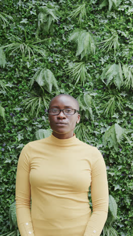 Vertical-video-of-portrait-of-happy-african-american-businesswoman-with-glasses-in-slow-motion