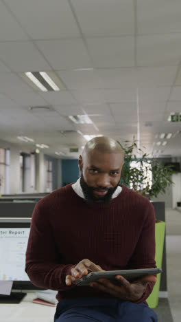 Vertical-video-of-portrait-of-african-american-businessman-with-tablet-in-slow-motion