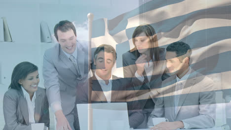 Waving-greece-flag-against-group-of-businesspeople-discussing-together-with-laptop-at-office