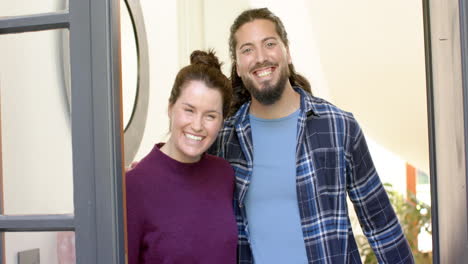 Happy-and-smiling-caucasian-couple-receiving-guests-in-sunny-home