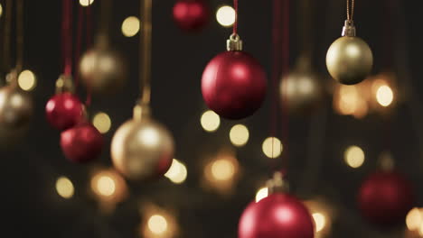 Video-of-gold-and-red-baubles-christmas-decorations-with-copy-space-on-black-background