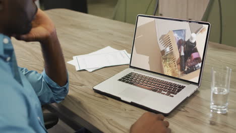 African-american-man-at-table-using-laptop,-online-shopping-for-beauty-products,-slow-motion