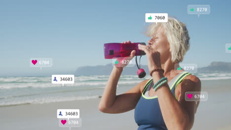 Animation-of-social-media-data-processing-over-caucasian-drinking-during-exercis-on-beach