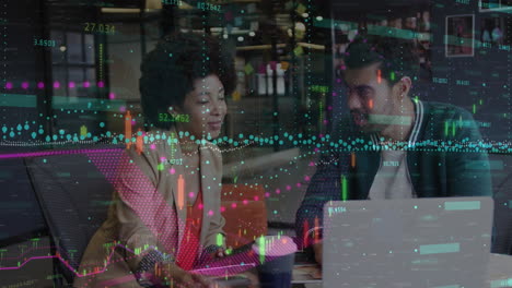 Animation-of-financial-data-processing-over-diverse-man-and-woman-discussing-over-laptop-at-office