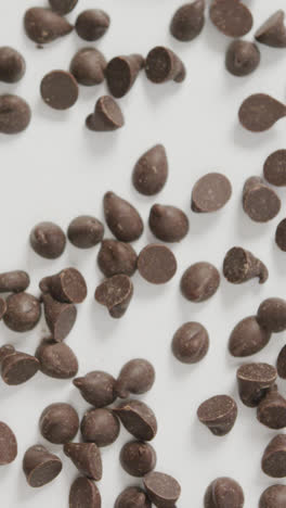 Video-of-overhead-view-of-multiple-chocolate-chip-over-white-background