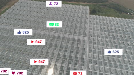 Animación-De-íconos-De-Redes-Sociales-Flotando-Contra-La-Vista-Aérea-De-Paneles-Solares-En-Pastizales