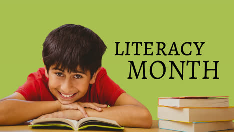 Animation-of-literacy-month-text-and-happy-biracial-boy-over-green-background