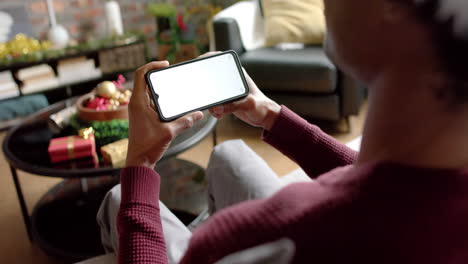 Happy-african-american-man-using-lsmartphone-with-copy-space-for-video-call-at-home,-slow-motion