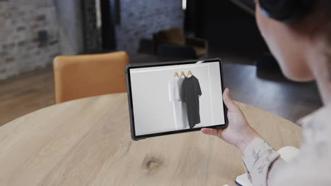 Biracial-woman-using-tablet-at-cafe-for-online-shopping,-slow-motion