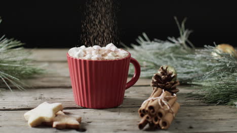 Video-of-red-mug-of-christmas-chocolate-with-marshmallows-and-copy-space-on-wooden-background