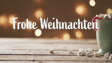 Frohe-Weihnachten-Text-With-Candy-Cane-In-Christmas-Hot-Chocolate-With-Marshmallows-And-Bokeh-Lights