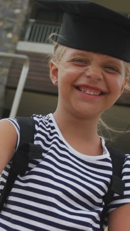 Video-of-happy-caucasian-girl-wearing-graduation-hat-and-holding-diploma