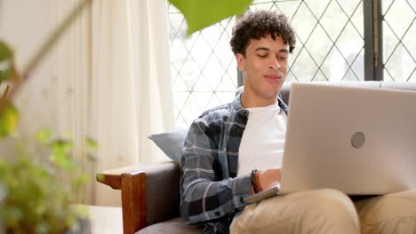 Biracial-man-working-from-home-using-laptop,-slow-motion