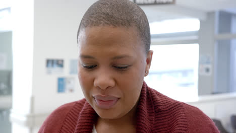 Portrait-of-happy-african-american-woman-in-hospital-reception,-slow-motion