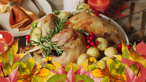 Animation-of-autumn-leaves-over-thanksgiving-dinner-background