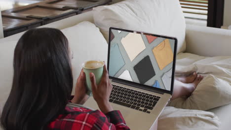 Biracial-woman-using-laptop-at-home-for-online-shopping,-slow-motion