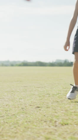 Video-of-legs-of-diverse-boys-playing-soccer-on-sports-field