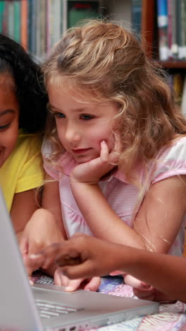 Vertical-video-of-diverse-girls-studying-together-at-school,-with-copy-space