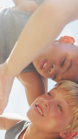 Video-of-happy-diverse-boys-holding-arms-and-talking