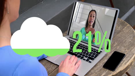 Animation-of-cloud-upload-icon-against-rear-view-of-woman-having-a-video-call-on-laptop-at-a-cafe