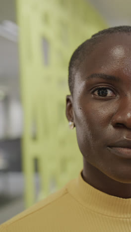 Vertical-video-of-portrait-of-happy-african-american-businesswoman-in-slow-motion