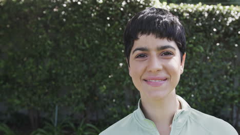 Happy-caucasian-woman-standing-and-smiling-in-sunny-garden,-copy-space,-slow-motion