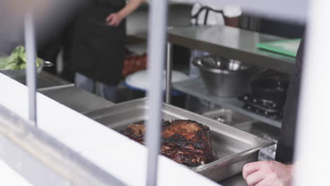 Groupd-of-diverse-male-chefs-standing-by-counter-in-kitchen,-slow-motion