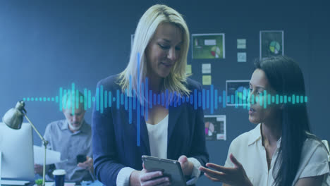 Animation-of-music-equalizer-over-diverse-female-colleagues-discussing-over-digital-tablet-at-office